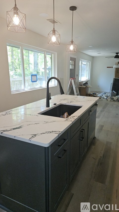 A kitchen under construction with a sink and a window.
