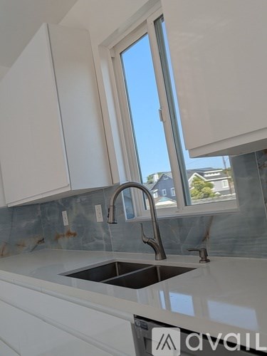 A kitchen with a sink and a window.