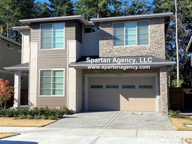 A two-story house with a garage is for sale by Spartan Agency, LLC.
