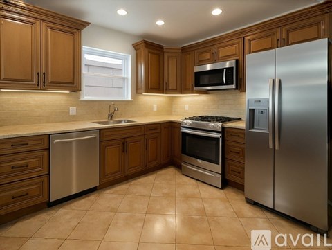A kitchen with wooden cabinets and stainless steel appliances.