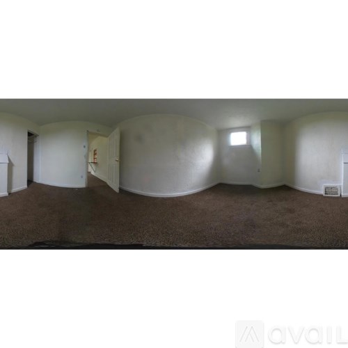 A room with a carpeted floor and a white ceiling.