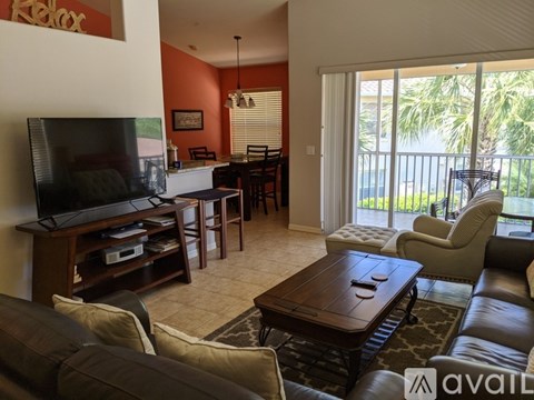 A living room with a brown leather couch and a wooden coffee table.