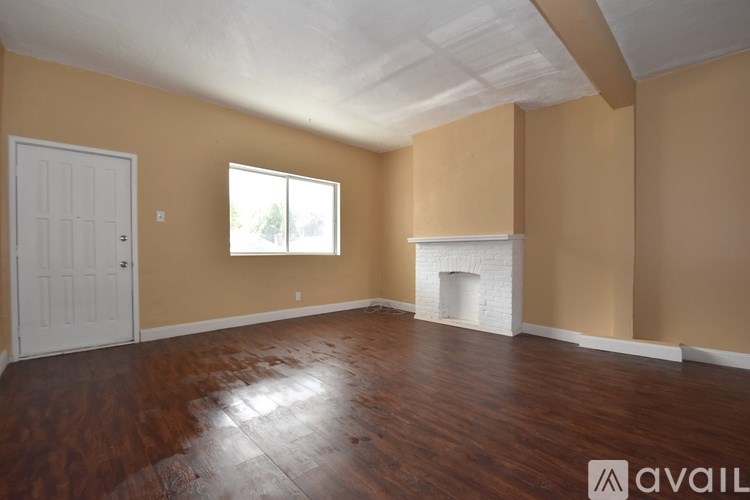 A room with a fireplace and a window.
