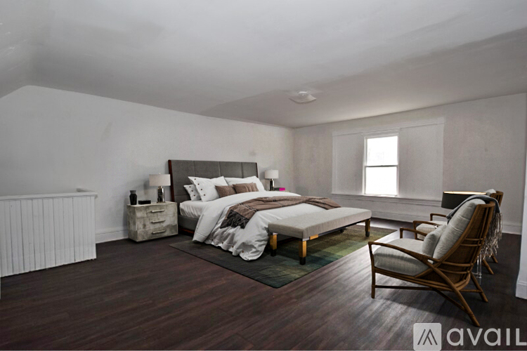 A kitchen with white cabinets and a wooden floor.