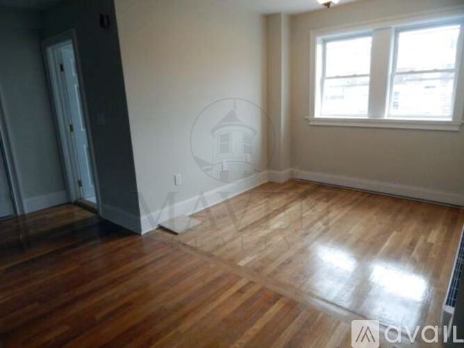 A room with wooden floors and a window.