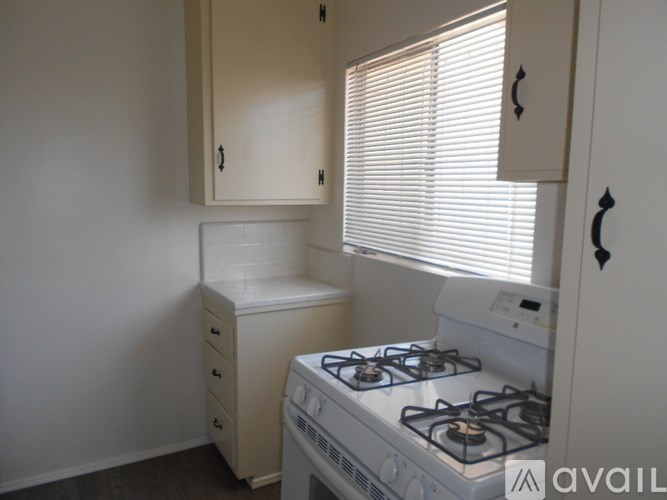 A small kitchen with a stove and a window.