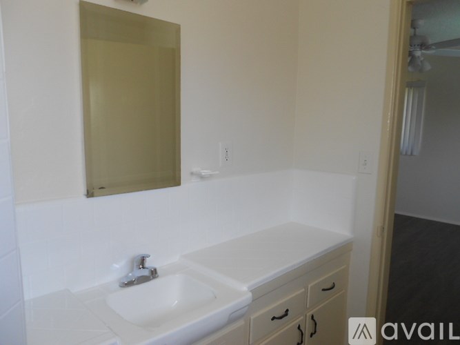 A bathroom with a sink and mirror.