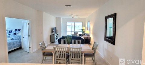 A dining room with a table and chairs is shown.
