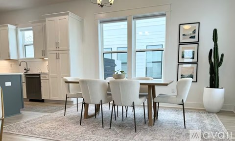 A dining room with a table set for four.