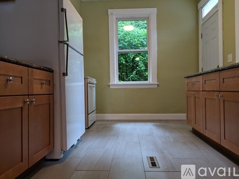A kitchen with wooden cabinets and a white refrigerator.