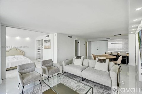 A modern living room with a glass coffee table and a white sofa.