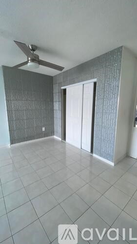 A room with a fan and a door.