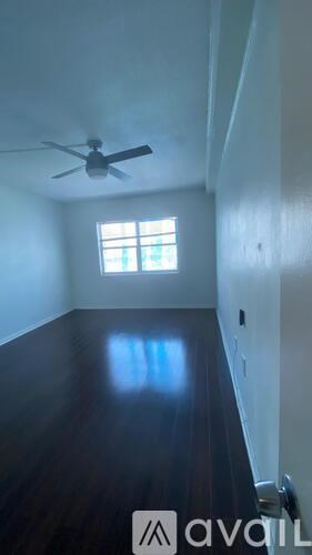 A room with a ceiling fan and a window.