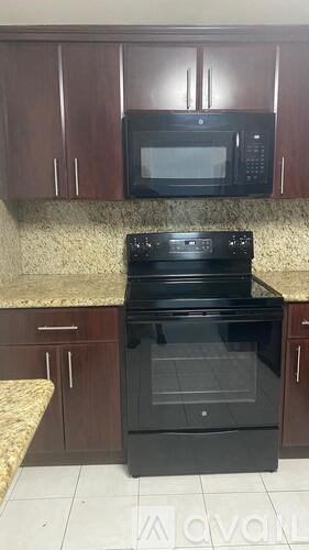 A black oven with a glass door is in a kitchen.
