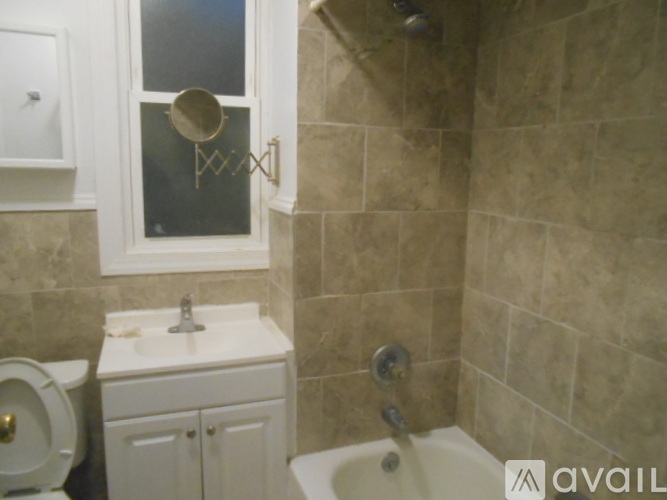 A bathroom with a toilet, sink, and tub.