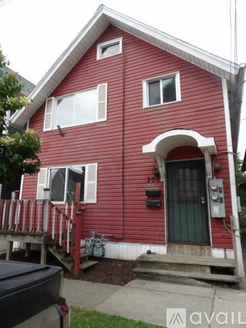 A red house with a black truck in front.