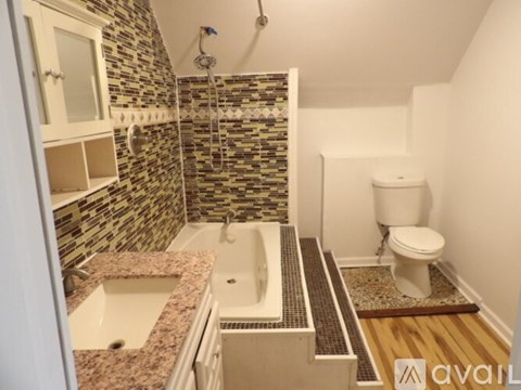 A bathroom with a tiled shower and a toilet.