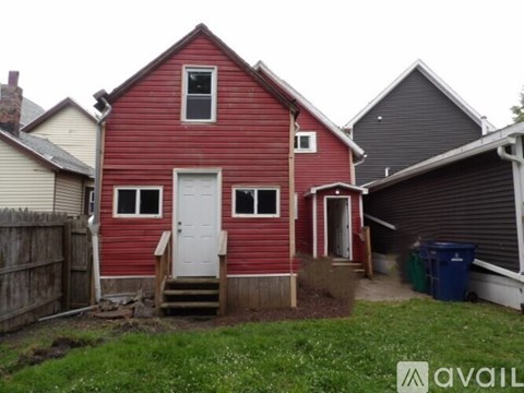 A red house with a white door and windows.