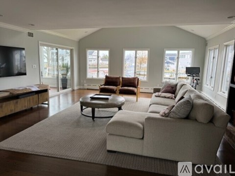 A living room with a large sectional sofa and a coffee table.
