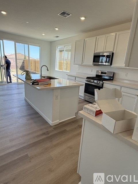 A kitchen with a box on the counter.