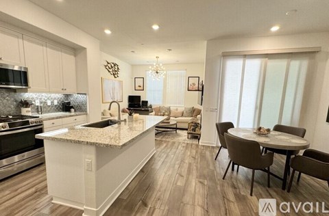 A modern kitchen with a dining table set for four.