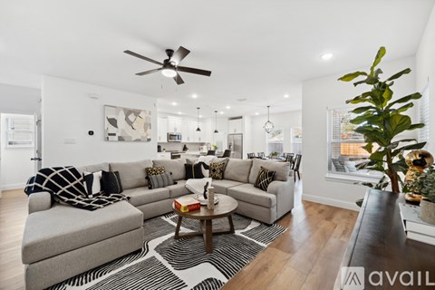 A living room with a grey couch and a coffee table.