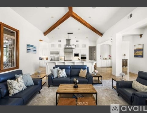 A living room with a dark blue sofa and a wooden coffee table.
