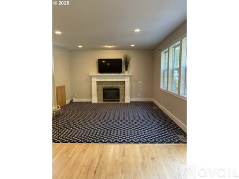 A living room with a fireplace and a television on the mantle.