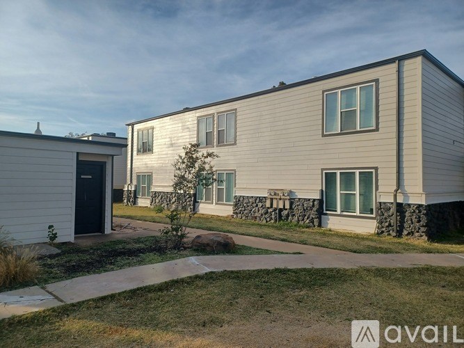 A modern two-story house with a garage and a front yard.