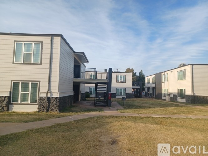 A row of houses with a grassy area in front.
