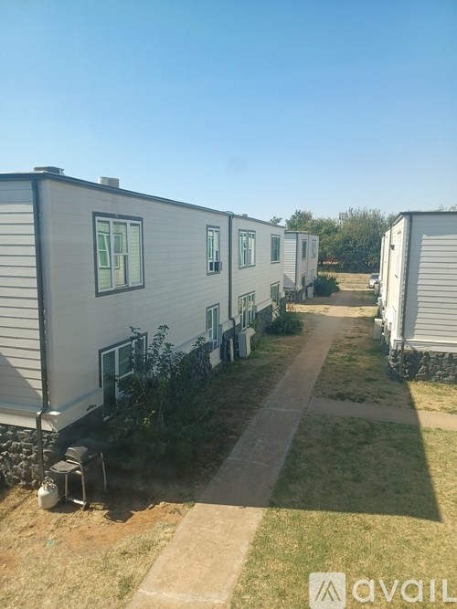 A row of mobile homes with a clear blue sky above.