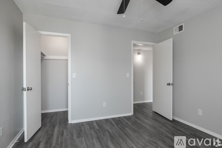 A room with a door on the left and a window on the right.