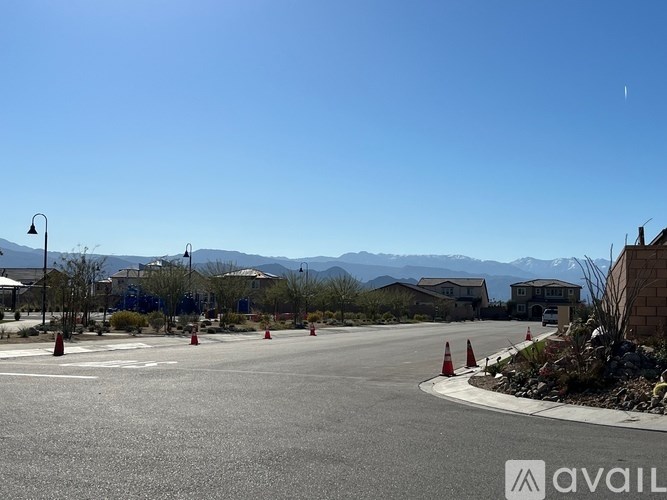 A road with traffic cones and a mountain in the background.