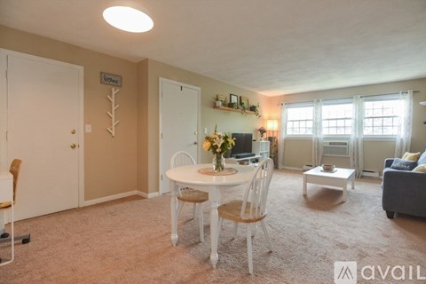 A living room with a dining table and chairs.