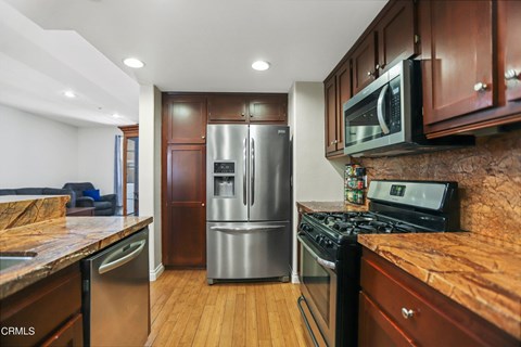 A kitchen with wooden cabinets and stainless steel appliances.