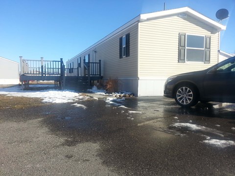 A house with a car parked in front of it.