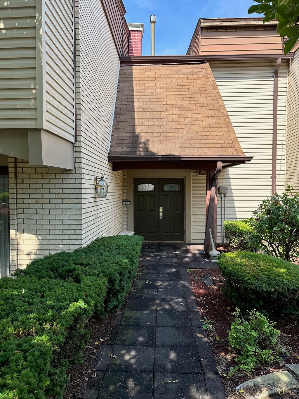 A house with a brown roof and a black door.
