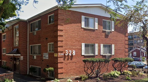 A red brick building with the number 328 on it.