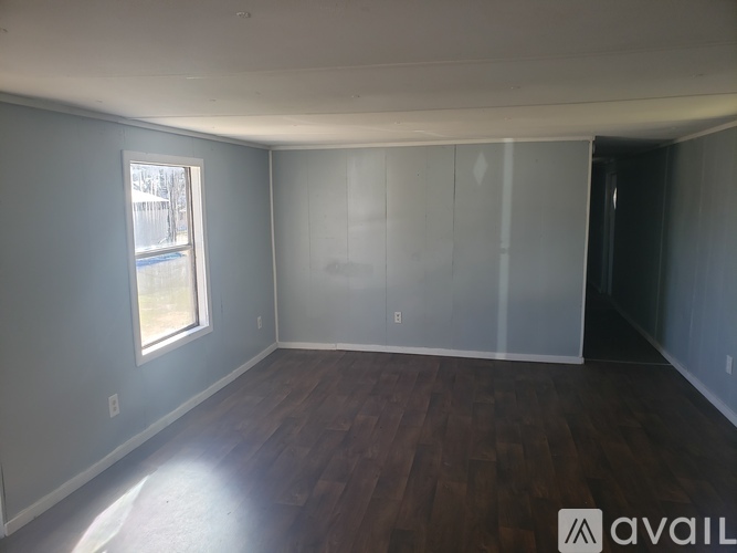 Empty room with wooden floor and white walls.