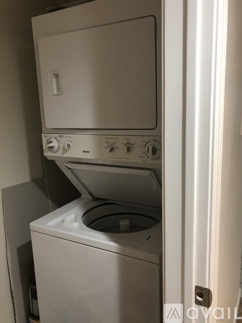 A white dishwasher is sitting in a kitchen.