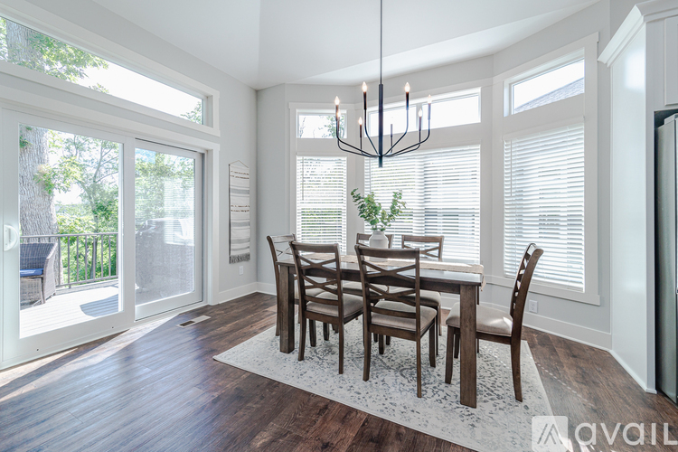 A dining room with a wooden table and chairs.