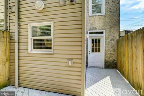 A house with a white door and a window with blinds.
