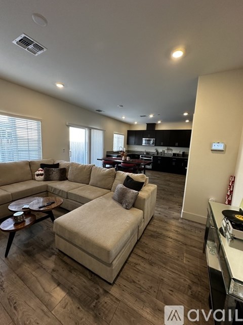 A living room with a beige sofa and a coffee table.