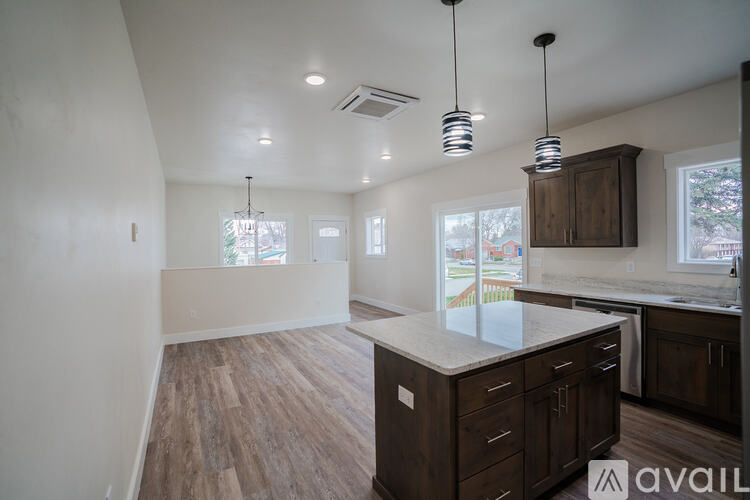 A kitchen with a counter and cabinets is available for rent.