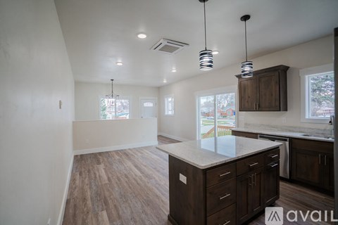 A kitchen with a counter and cabinets is available for rent.