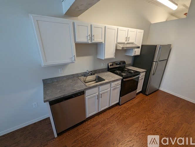 A kitchen with white cabinets and stainless steel appliances.
