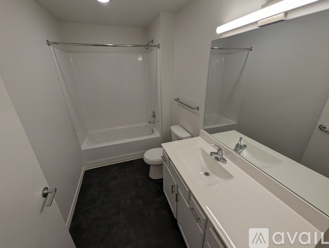A bathroom with a white sink, toilet, and bathtub.