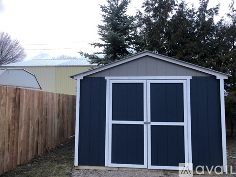 A blue garage door with a white frame.