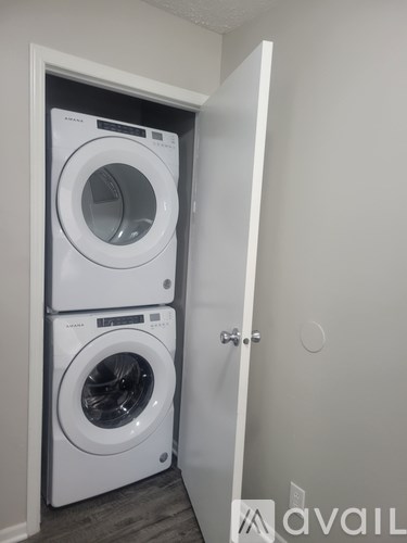 A white washing machine and dryer in a small laundry room.