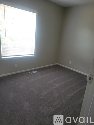A room with a window and Avail logo on the floor.